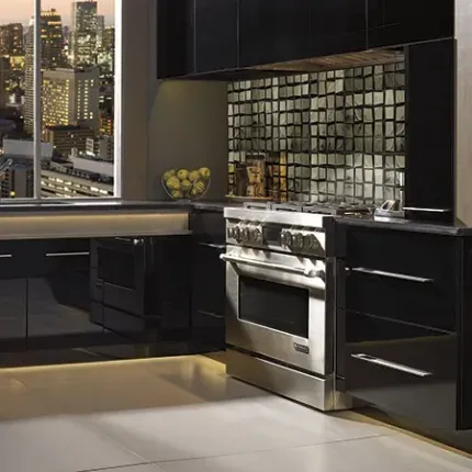 kitchen corner with stainless steel oven and black omega cabinets